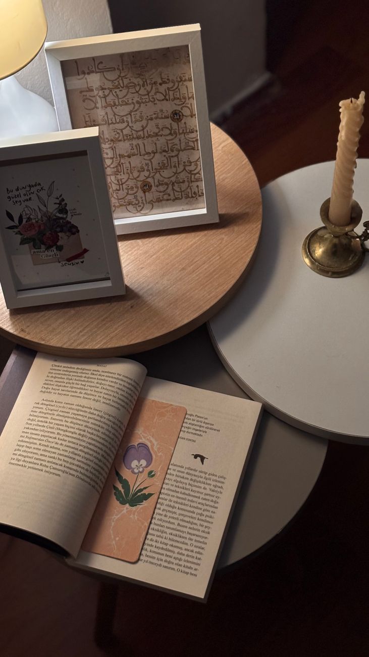A small reading nook with framed art and a candle in soft light — the accent layer that finishes the room.